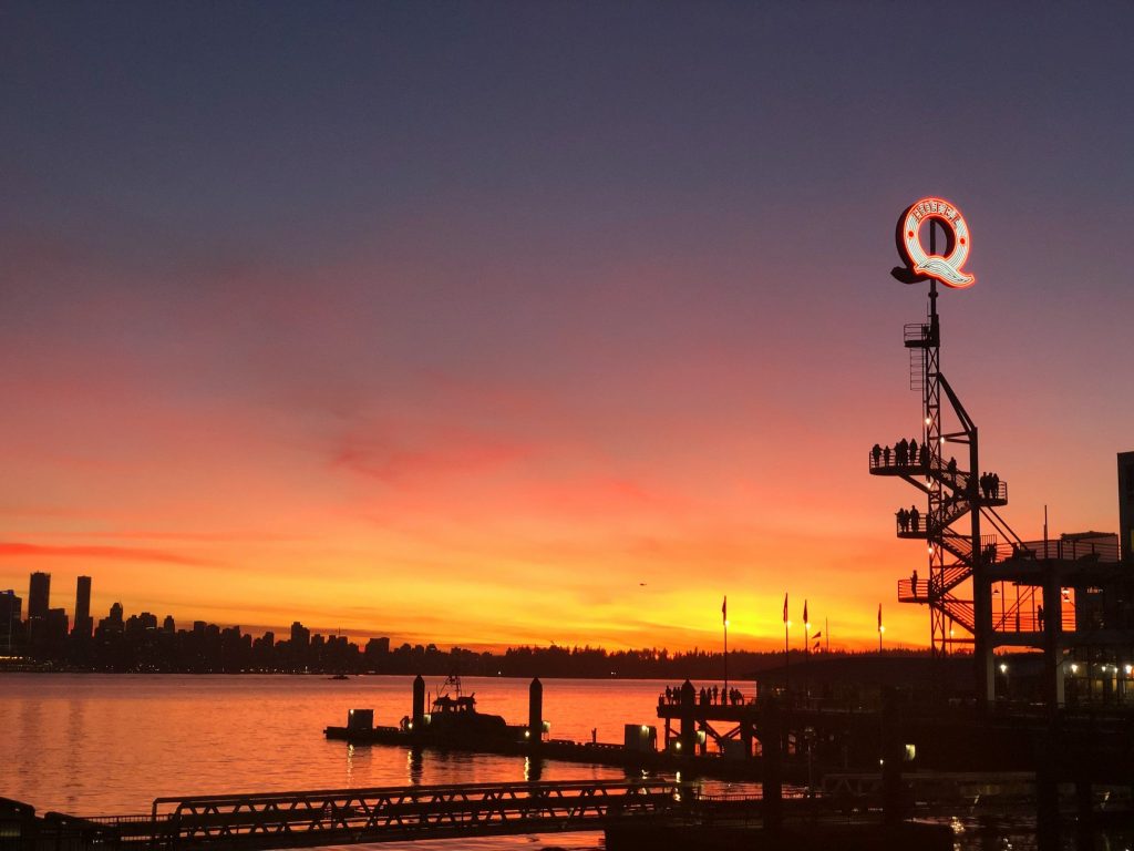 Sunset over Burrard Inlet and the Vancouver skyline from Lonsdale Quay in North Vancouver