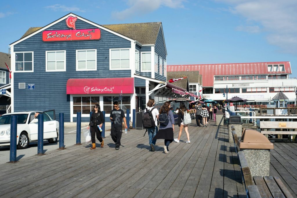 People walking along the Steveston boardwalk in Richmond