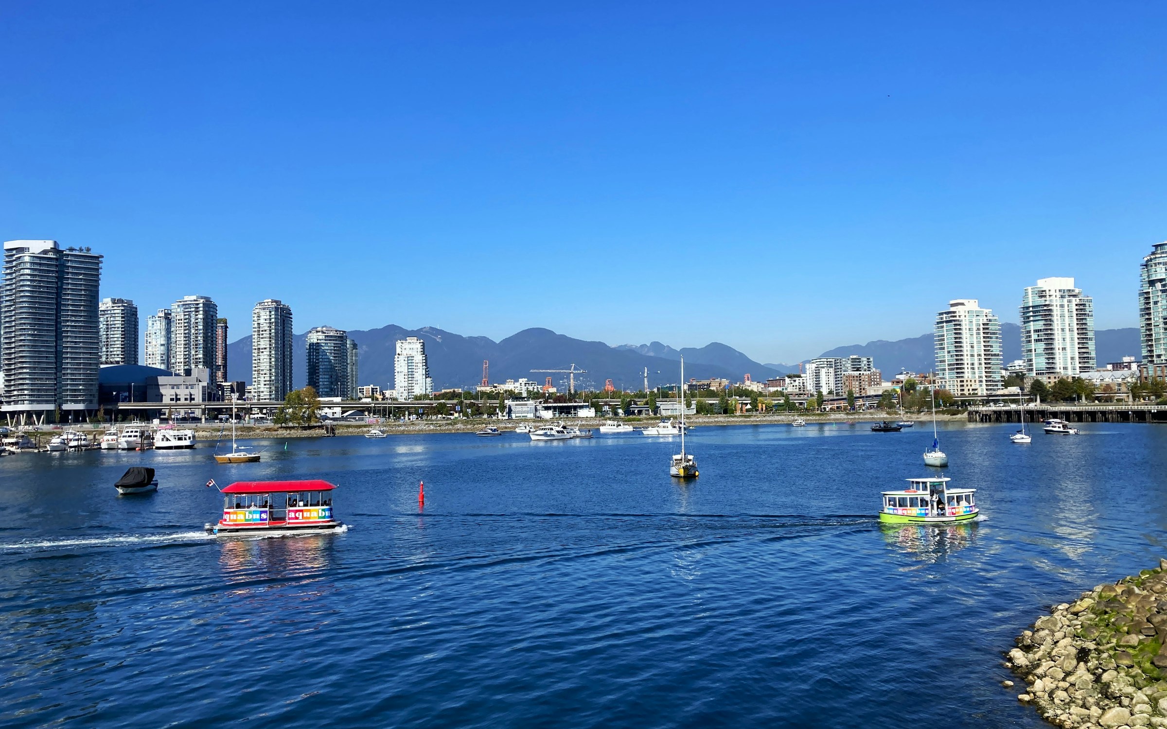 Boats on False Creek with the Vancouver skyline and mountains