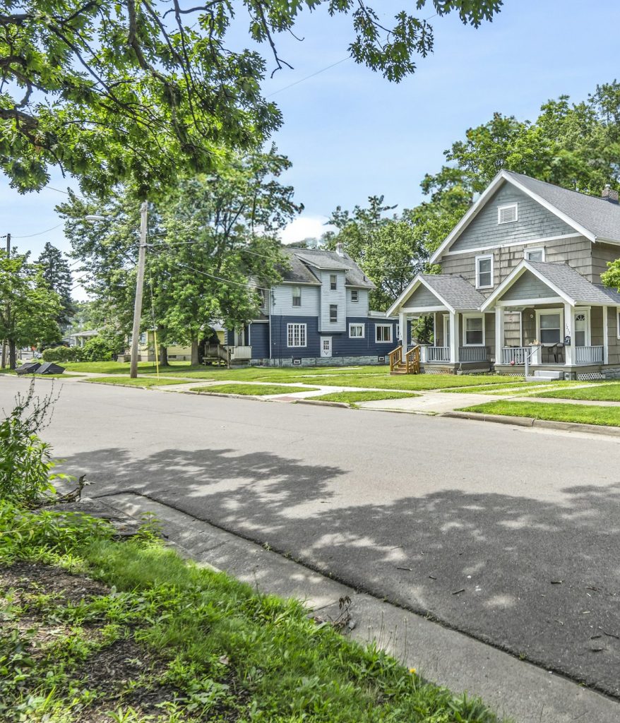 Houses on a quiet, tree-lined residential street